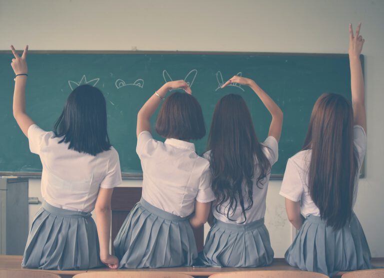 Four girls wearing school uniforms